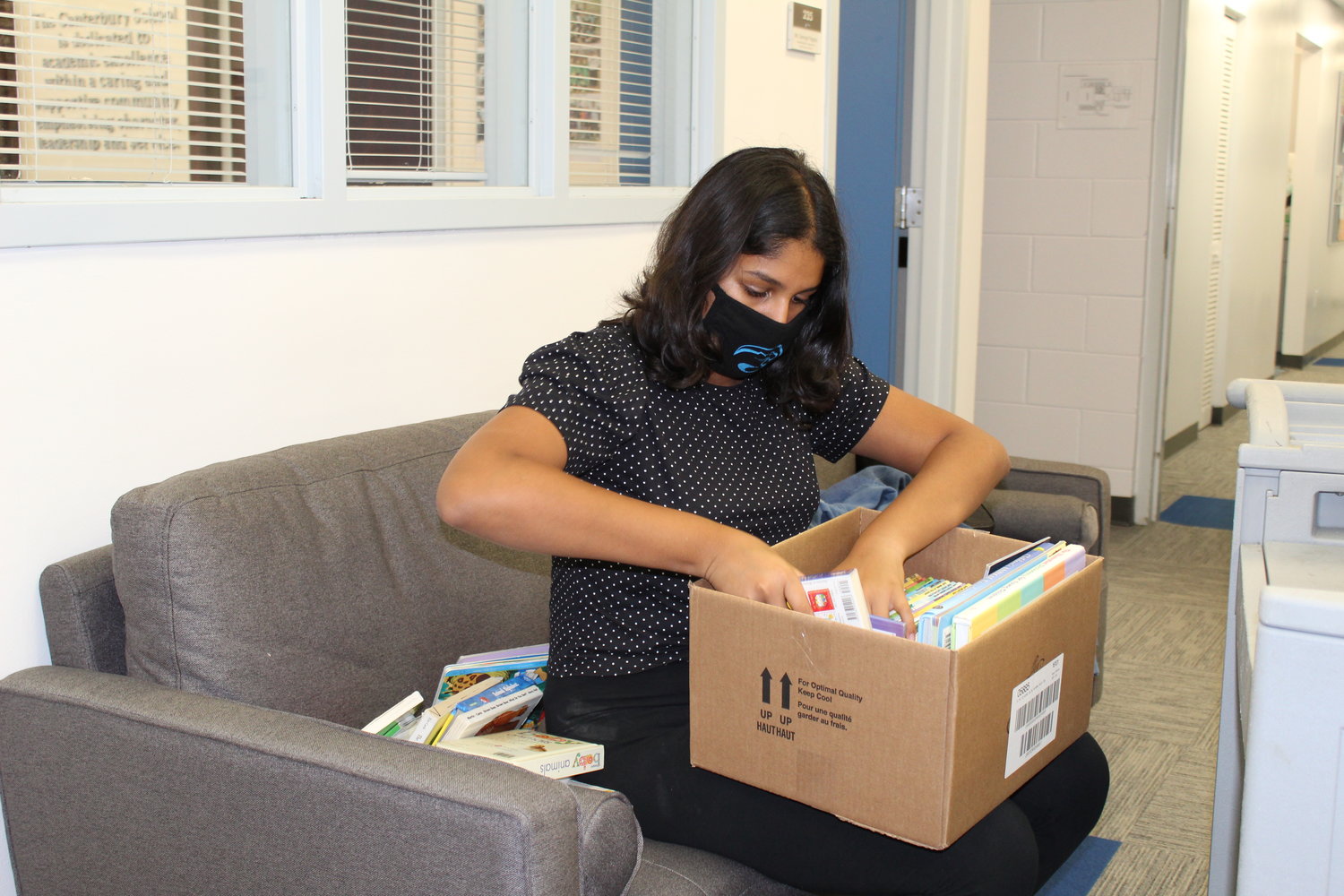 Natasha Agarwal boxes children’s books collected through BelieveNBooks’ drive at Canterbury School.